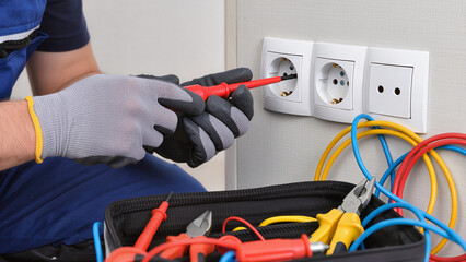 electrician repairing electrical outlet