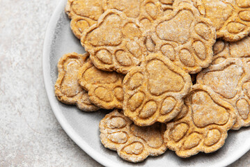 Homemade paw print dog treats on a plate