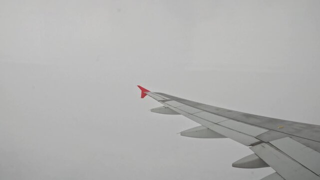 Airplane wing view from inside plane during flight