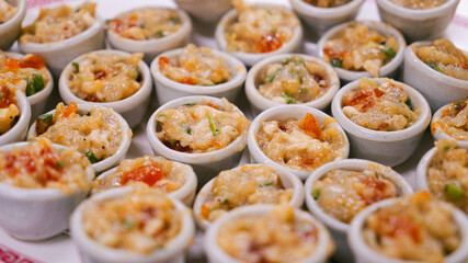 Steamed dumplings served in small ceramic cups