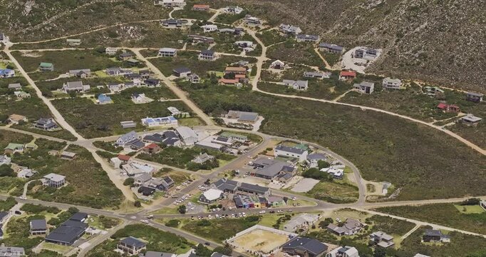 Pringle Bay South Africa Aerial v3 zoomed birds eye view flyover the coastal village capturing the townscape, residential houses and hillside views - Shot with Mavic 3 Pro Cine - Jan 9th 2024