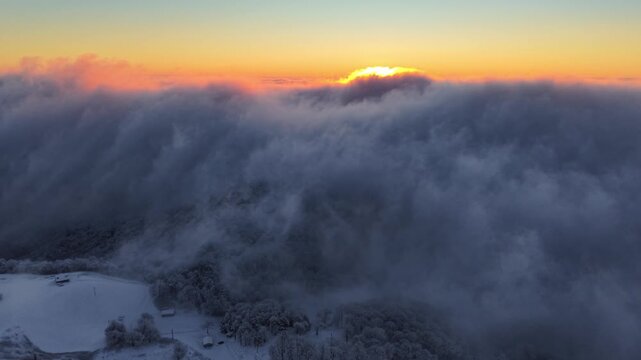 aerial tiltdown from sunrise and clouds after snowstorm near boone nc, north carolina