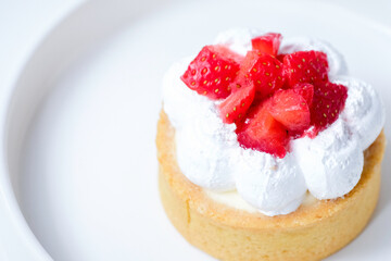 Strawberry cheese tart on a white plate