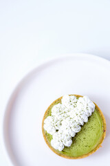 Matcha cheese tart on a white plate