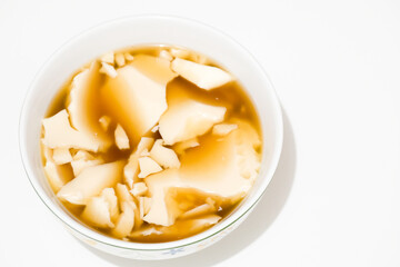 Kembang tahu is soybean pudding in ginger and palm sugar syrup, Indonesian traditional food