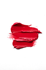 three Red lipstick smudged smears on white background. Lipstick or other makeup product swatch