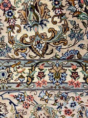 Close-up of a detailed, traditional floral carpet pattern.