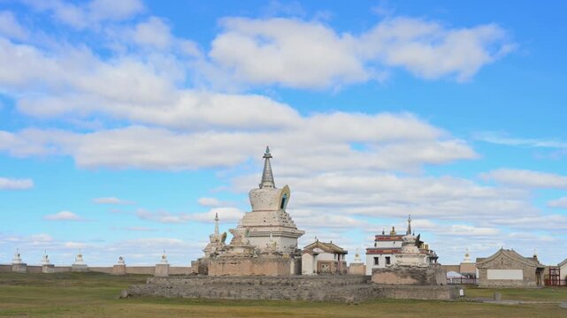 Wide shot of Erdene Zuu Monastery, Mongolia. Ancient white Buddhist stupas and historic temple walls under a bright blue sky in Kharkhorin.
