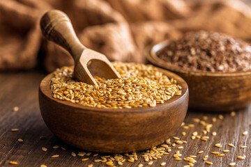 Golden linseed or flaxseed. Healthy flax seed in bowl on wooden table.