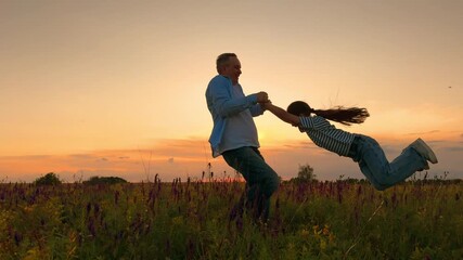 Dancing in the sunset field, Father and daughter joy, Wildflower happiness, Evening warmth and laughter, Silhouette stories of love, Fields of joy and connection, Beautiful moments at dusk, Parental