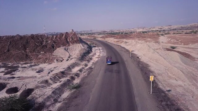 Upward-Moving Drone Shot Revealing  Trucks on  Makran Coastal Highway, Balochistan, Pakistan