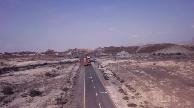 Upward Aerial Drone Shot of Canyons, Revealing Trucks Makran Coastal Highway, Balochistan, Pakistan
