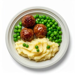 Overhead View of Three Meatballs with Peas and Mashed Potatoes on Beige Plate