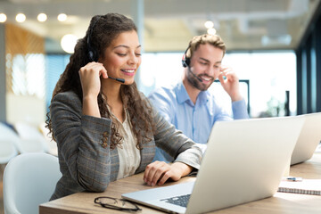 Friendly and helpful customer service support specialists in work.