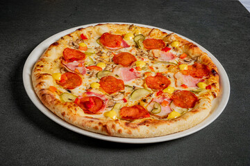 A delicious pizza with pepperoni, veggies, and sauces, great for sharing with friends