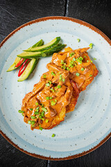 Enjoy a gourmet meal of perfectly cooked meat, flavorful sauce, and vibrant vegetables