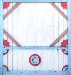 Vintage wooden shutter with peeling paint and rustical naive handmade decor. Retro wood door with simple hand-carved decor. Mock up template. Copy space for text