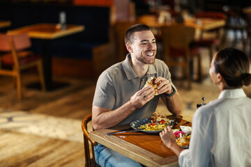 Young couple enjoying lunch date at a modern restaurant