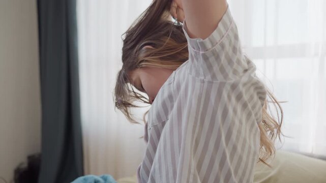 Sitting White Girl Running Hands Through Hair By Window, Long Strands Flipping With Daylight And Curtain Backdrop, Casual Grooming And Morning Ritual Scene For Beauty And Lifestyle Content