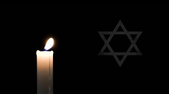 A burning candle and Star of David on black background. Symbol of remembrance and grief for holocaust day or memorial day.
