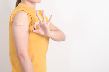 Adult Woman with bandage after received vaccine. Vaccination and Immunization for Influenza, HPV,...