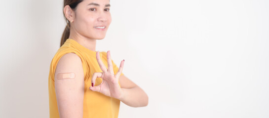 Adult Woman with bandage after received vaccine. Vaccination and Immunization for Influenza, HPV,...