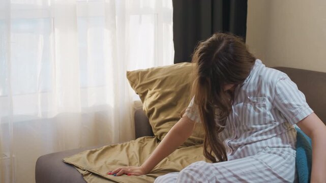 Tired Woman Settles Down On Comfortable Sofa, Exhausted Woman Reclines On Sofa In Gentle Morning Light, Fatigued Woman Finds Repose On Sofa While Morning Sunlight Softly Filters Through