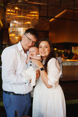 Family celebration in a restaurant with their baby