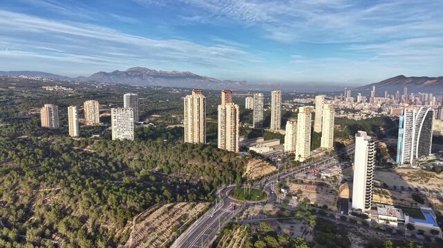 Aerial Morning View Of Skyscrapers Emerging From Dense Pine Woodland With Distant Mountain Range Architecture