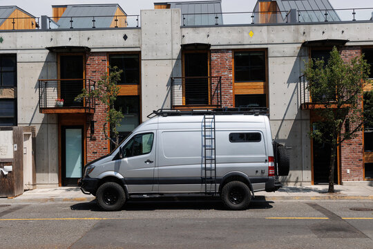 Camper van parked in front of industrial apartments in Oregon