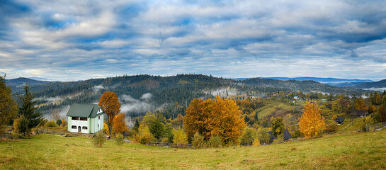 Sunny Autumn Carpathians with Puffy White Clouds