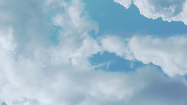 Airplane window view, aerial drone view sunny blue sky fluffy white clouds in sunlight on sunny day time lapse.Beautiful azure scyscraper and white cloudscape, firmament, atmosphere, blue sky cloud. 