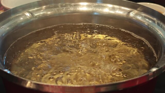 Close-Up of Bubbles Forming in Boiling Water in a Pan