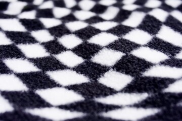 Black and white checkered square soft fur textured fabric rug object isolated on horizontal ratio background for wallpaper.