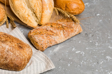 Homemade natural breads. Different kinds of fresh bread as background, perspective view with copy space