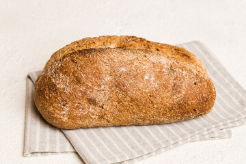 Assortment of freshly baked bread with napkin on rustic table top view. Healthy unleavened bread. French bread