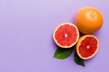 fresh Fruit grapefruit with Juicy grapefruit slices on colored background. Top view. Copy Space. creative summer concept. Half of citrus in minimal flat lay with copy space