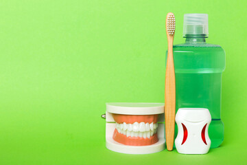 Mouthwash and other oral hygiene products on colored table top view with copy space. Flat lay. Dental hygiene. Oral care kit. Dentist concept