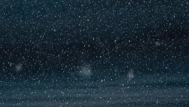 Soft snowflakes dance gracefully in the quiet night sky