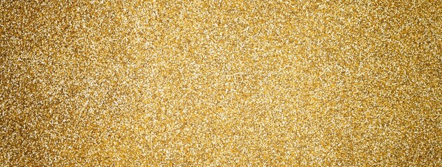 Gold sparkling background from small sequins, macro. Shiny golden glitter backdrop for Christmas or New Year