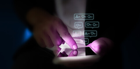 Finger of man touching scroll page app on mobile phone.with blue and purple neon tones.concept...