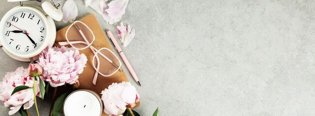 Feminine Workspace with Clock, Flowers, and Stationery