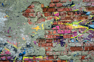 Abstraction of crumbling graffiti on a city street wall. Colorful abstract background. Old, cracked, peeling paint on the wall as a background.