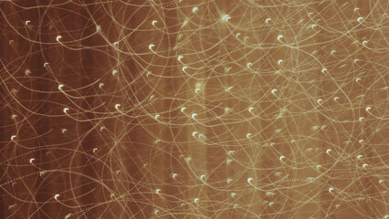 Golden abstract light trails creating dynamic, swirling patterns on a warm background; ideal for...