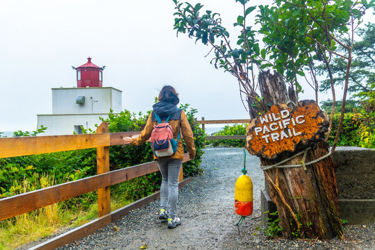 Tourist walking on the wild pacific trail in ucluelet, vancouver island