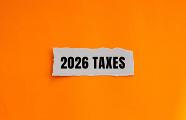 2026 Taxes message written on ripped torn paper background. Conceptual 2026 Taxes symbol. Copy space.