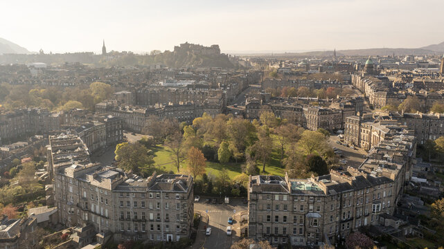 Aerial view of Edinburgh Castle watches over the city's symmetrical Georgian architecture and lush green spaces, Moray Feu, Scotland, United Kingdom.