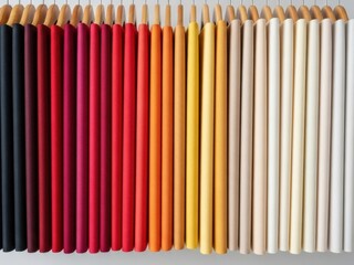 Colorful array of pencils in various hues on white background for art and design