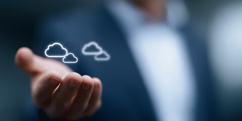 A person holding cloud icons to represent a cloud computing. This photorealistic image focuses on technology and business.
