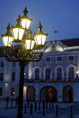 Vintage street lamps glowing at blue hour in Tallinn Old Town during winter
